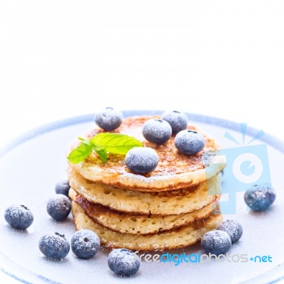 Pile Of Pancakes With Blueberries Sprinkled With Icing Sugar Stock Photo