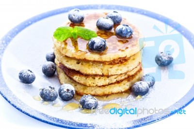 Pile Of Pancakes With Blueberries Sprinkled With Icing Sugar And… Stock Photo