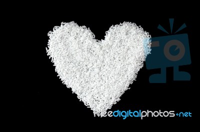 Pile Of Rice Seed By Heart Shape On The Black Background For Isolated Stock Photo