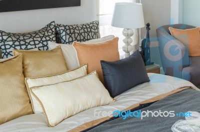 Pillows On Luxury Bed With White Lamp In Bedroom Stock Photo