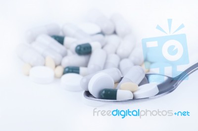 Pills And Tablets On Spoon Stock Photo