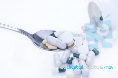 Pills And Tablets On Spoon Stock Photo