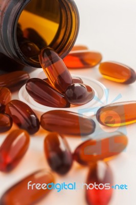 Pills Capsule Spilling Out Of A Bottle Stock Photo