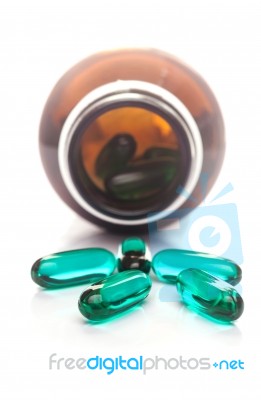 Pills Capsule Spilling Out Of A Bottle Stock Photo