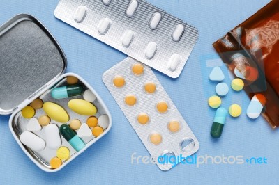 Pills On Blue Background Stock Photo