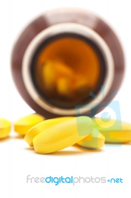 Pills Spilling Out Of A Bottle Isolated, Selective Focus Stock Photo