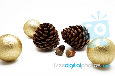 Pine Cone And Acorn With Gold Ball Ornament On White Background Stock Photo