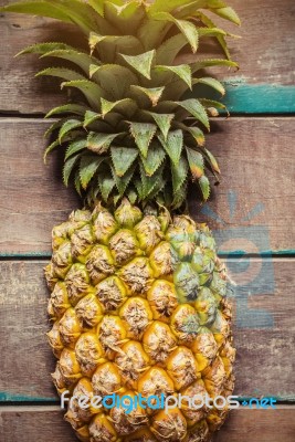 Pineapple On The Wooden Stock Photo