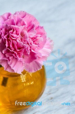 Pink Artificial Flower In Brown Round Bottle Stock Photo