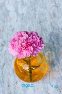 Pink Artificial Flower In Brown Round Bottle Stock Photo