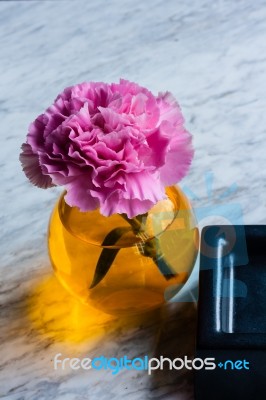 Pink Artificial Flower In Brown Round Bottle Stock Photo