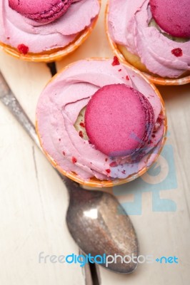 Pink Berry Cream Cupcake With Macaroon On Top Stock Photo