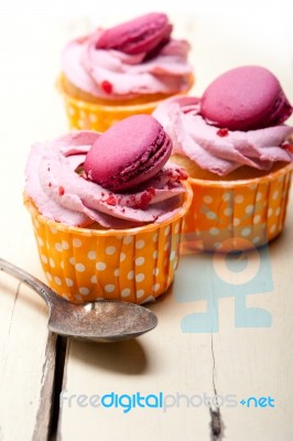 Pink Berry Cream Cupcake With Macaroon On Top Stock Photo