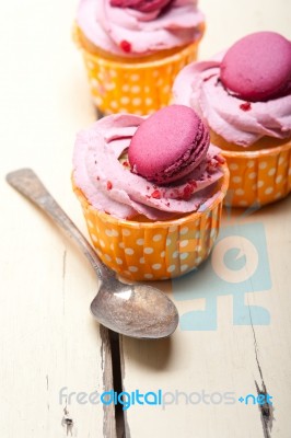 Pink Berry Cream Cupcake With Macaroon On Top Stock Photo