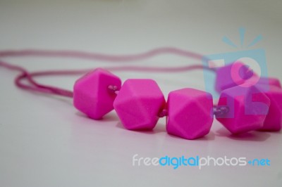 Pink Breastfeeding Necklace For Baby And Mom Stock Photo