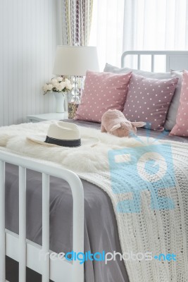 Pink Pillows With Pink Doll On White Wooden Bed And Classic Hat Stock Photo