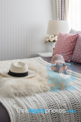 Pink Pillows With Pink Doll On White Wooden Bed And Classic Hat Stock Photo