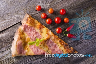 Pizza Cut On Wooden Table Stock Photo