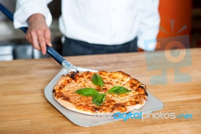 Pizza Taken Out Of The Oven, Ready To Be Served Stock Photo