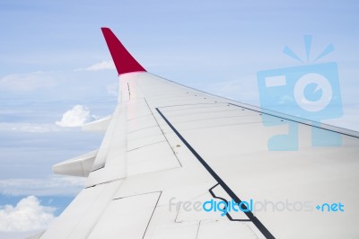 Plane Wing On Cloudy Blue Sky Background Stock Photo