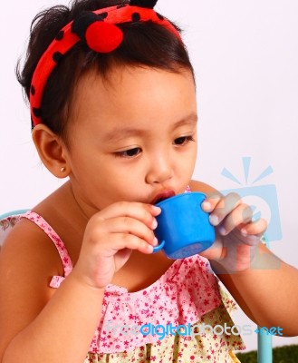 Play Acting With Toy Cup Stock Photo