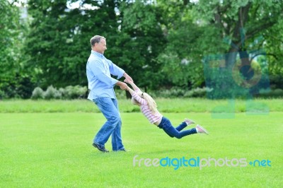 Playful Father And Daughter Having Fun In Garden Stock Photo