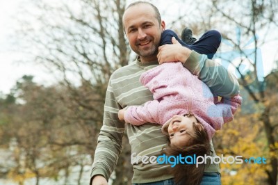 Playful Father And Daughter In Park Stock Photo