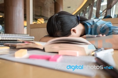 Playful Schoolgirl With Two Hair Tails Sitting Behind The Small Stock Photo