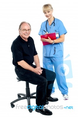 Pleasing Doctor Collecting Patient's Health History Stock Photo