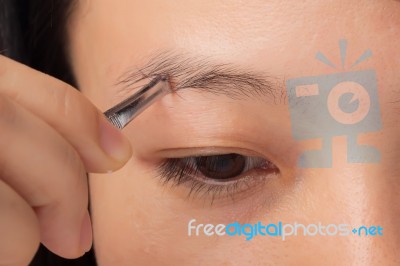 Plucking Eyebrows Stock Photo