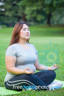 Plus Size Woman Practicing Yoga Stock Photo