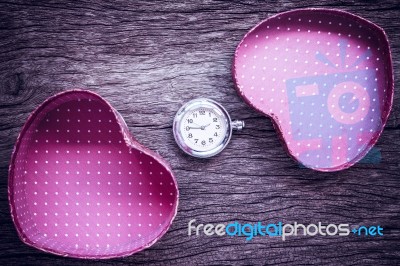 Pocket Watch And Gift In Heart Shape On The Background. Vintage Stock Photo