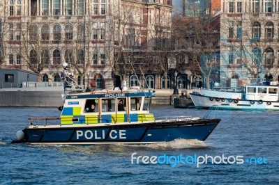 Police Launch Cruising Along The River Thames Stock Photo