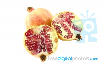 Pomegranate And Two Half On White Background Stock Photo