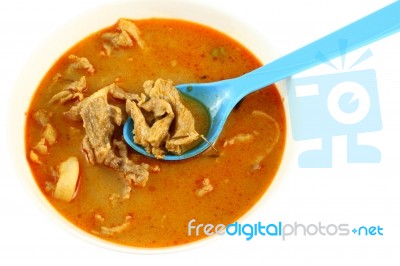 Pork Spicy Curry With Blue Spoon On White Background Stock Photo