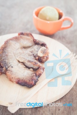 Pork Steak On Wooden Plate Stock Photo