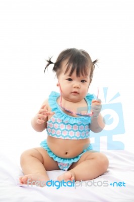 Portrait Baby Girl In Swimsuit On White Background Stock Photo