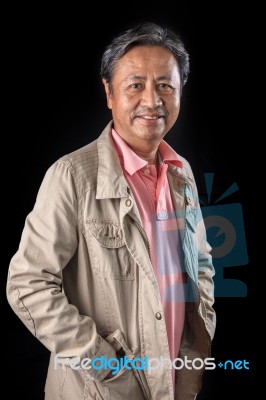 Portrait Close Up Smiling Happiness Face Of 59s Years Old Asian Man With Studio Light Against Black Background Stock Photo