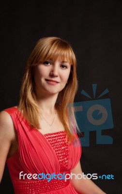 Portrait Of A Beautiful Young Woman In A Red Dress Stock Photo