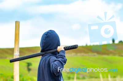 Portrait Of A Boy Holding A Wooden Sword Play Stock Photo