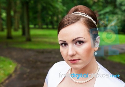 Portrait Of A Bride In A City Park Stock Photo