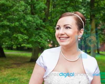 Portrait Of A Bride In A City Park Stock Photo