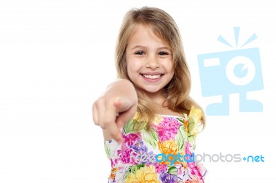 Portrait Of A Cheerful Kid Pointing Towards You Stock Photo