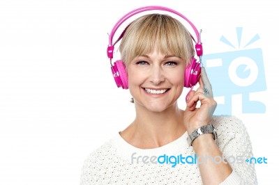 Portrait Of A Cheerful Woman With Headphones On Stock Photo