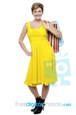 Portrait Of A Happy Woman Carrying Shopping Bags Stock Photo