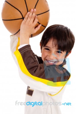 Portrait Of A Kid Throwing Ball At Camera Stock Photo