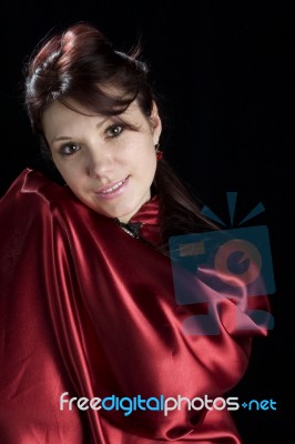 Portrait Of A Red Hair Smiling Women In Red Gown Stock Photo