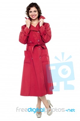 Portrait Of A Trendy Woman In Maroon Overcoat Stock Photo