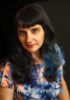 Portrait Of A Young Brunette Woman With Long Hair Stock Photo