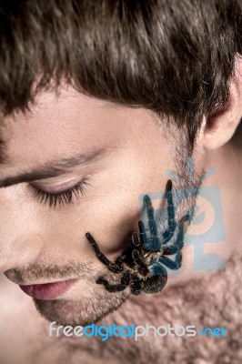 Portrait Of A Young Handsome Man With Spider On His Face Stock Photo